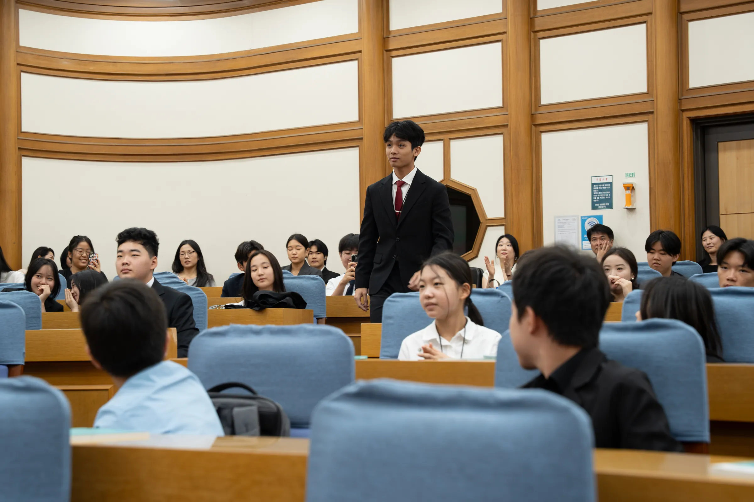 An award winner rises in the hall, KNAMUN 2026.