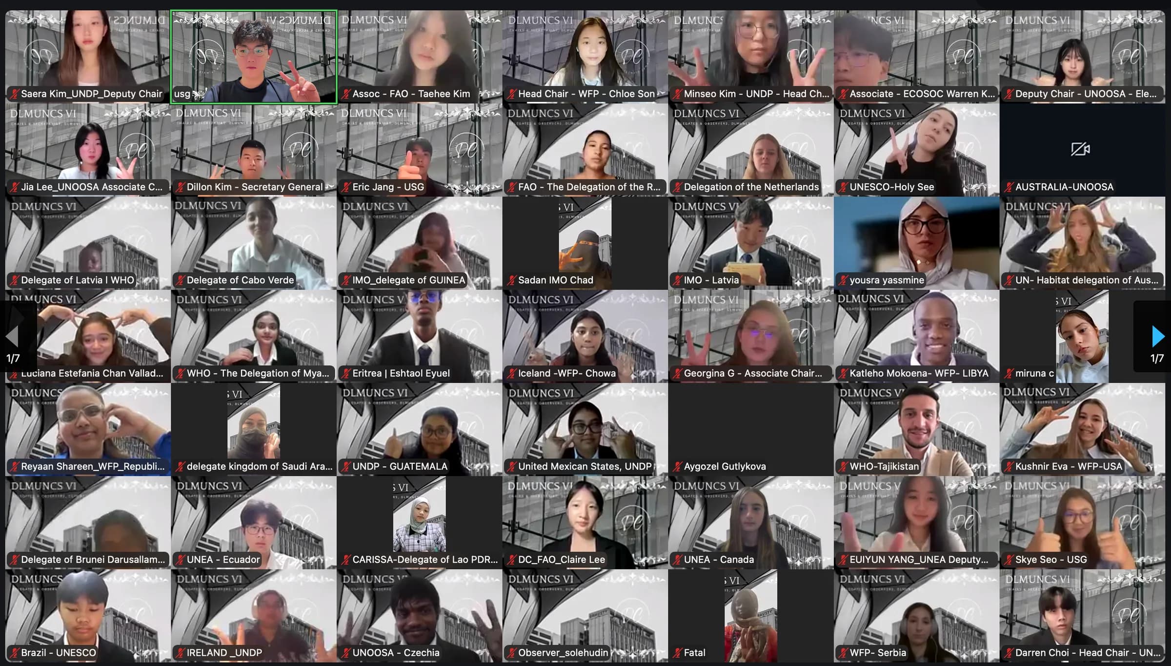 The DLMUNCS VI opening ceremony on Zoom, page one of a 335-person gallery: secretariat, chairs and delegates from around the world, several making peace signs and thumbs-up.
